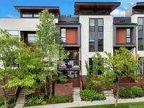 Contemporary townhome featuring a modern design with a private balcony and well-maintained landscaping at 1880 W 32Nd Ave, Denver, CO 80211