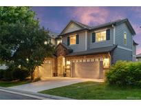 Charming two-story home with a three-car garage, brick accents, neutral siding, and a well-manicured lawn at 5984 S Paris Pl, Greenwood Village, CO 80111