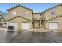 Charming townhome featuring an attached garage and welcoming front porch area at 3200 S Federal Blvd # 5, Denver, CO 80236