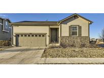 Charming single Gathering home featuring stone accents, a two car garage and neutral tones at 18187 E 99Th Ave, Commerce City, CO 80022