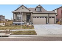 Charming home with a covered porch, two-car garage, and well-maintained landscaping at 152 Western Sky Cir, Longmont, CO 80501
