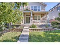 Charming front porch with brick accents, inviting entrance, and well-maintained landscaping at 9523 Gray Ct, Westminster, CO 80031