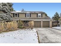 Two-story house with a brown exterior, two-car garage, and solar panels on the roof at 7261 E Hinsdale Ave, Centennial, CO 80112