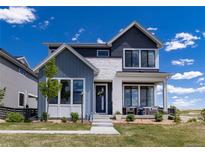 Charming two-story home boasting a mix of siding and stone finishes with beautifully landscaped front yard at 6235 Stable View St, Castle Pines, CO 80108