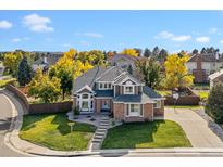 Beautiful two-story brick home with a well-manicured lawn and mature trees in a desirable neighborhood at 9163 Winrow Ct, Highlands Ranch, CO 80126