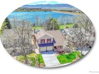 Beautiful two-story home featuring a finished two-car garage and gorgeous water views at 2590 W Long Cir, Littleton, CO 80120