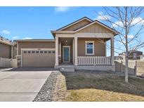 Charming single-Gathering home showcasing a quaint front porch and a two-car garage at 9284 E 105Th Ave, Commerce City, CO 80640