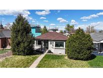 Charming home featuring new roof, brick accents, mature trees and a well-manicured lawn at 3155 N Steele St, Denver, CO 80205