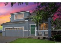 Two-story house with gray siding, green door, and a landscaped lawn at 20493 E Hampden Pl, Aurora, CO 80013
