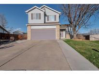 Two-story home boasts an attached garage, well-maintained lawn, and a classic suburban facade at 5431 E 129Th Ave, Thornton, CO 80241