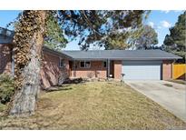 Brick ranch home with attached garage and mature landscaping at 558 S Pontiac Way, Denver, CO 80224