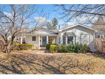 Charming single Gathering home with a beautifully landscaped front yard and inviting blue entry door at 1900 S Gilpin St, Denver, CO 80210