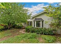Charming home featuring lush landscaping, a bay window, and a stone pathway leading to the front door at 1900 S Gilpin St, Denver, CO 80210