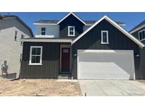 Modern two-story home featuring a gray exterior, a two-car garage, and a red front door at 13350 Blue Amber Ct, Parker, CO 80134