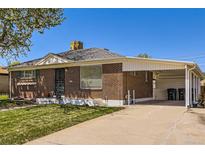 Charming brick home with a well-manicured lawn and a convenient carport, perfect for easy parking at 1475 Lucille Ct, Northglenn, CO 80233