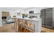 Bright kitchen featuring stainless steel appliances, white cabinetry, and an island with seating at 8190 Raleigh Pl, Westminster, CO 80031