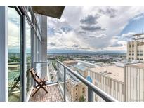 Enjoy city views from this condo's private balcony with glass railings and a seating area at 891 14Th St # 2002, Denver, CO 80202