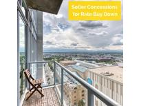 Relax on this balcony with its glass railing and wood flooring, boasting panoramic city views at 891 14Th St # 2002, Denver, CO 80202