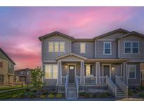 Charming two-story townhome with a covered front porch and beautiful landscaping at 2419 Flats St, Erie, CO 80516