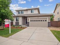 Charming two-story home boasts a well-manicured lawn, neutral siding, and an attached two-car garage at 15350 W 50Th Dr, Golden, CO 80403
