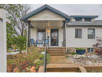 Charming home featuring a covered front porch with seating and stone accents at 4001 Kalamath St, Denver, CO 80211