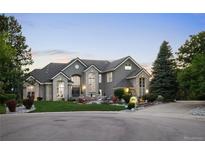 Beautiful gray exterior featuring manicured landscaping, stone accents, and a grand entrance at 11362 W Baltic Ct, Lakewood, CO 80227