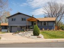Charming two-story home with landscaped front yard, covered porch, and lovely curb appeal at 6500 S Downing St, Centennial, CO 80121