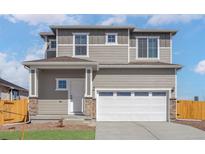 Charming two-story home featuring neutral siding, a two-car garage, and a well-maintained front yard at 9484 Yampa St, Commerce City, CO 80022
