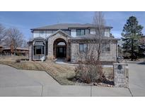 Charming two-story home with a brick facade, arched entry, and well-maintained front yard and inviting curb appeal at 5284 Taft Ct, Arvada, CO 80002