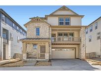 Beautiful two-story home with stone accents, covered porch and balcony at 7213 Waterleaf Trl, Littleton, CO 80125