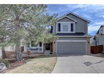 Charming two-story home with a well-manicured lawn and an attached two-car garage at 2888 Deer Creek Trl, Highlands Ranch, CO 80129