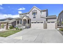 Charming two-story home with a three-car garage, covered porch and well-manicured lawn at 7167 Hyland Hills St, Castle Pines, CO 80108