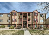 Inviting condo with wood accents and landscaped front yard for a warm, welcoming appeal at 8770 Corona St # 102, Denver, CO 80229