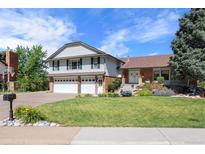 Charming two-story home with a well-manicured lawn, three-car garage and beautiful landscaping at 7629 S Fillmore Way, Centennial, CO 80122