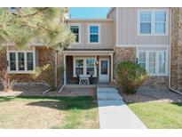 Charming two-story townhouse with stone accents and a well-maintained front yard, creating a welcoming curb appeal at 9671 W Chatfield Ave # B, Littleton, CO 80128