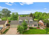 Charming home featuring a well-manicured lawn and inviting two-car garage at 8896 W Prentice Ave, Littleton, CO 80123