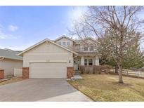 Charming two-story home featuring a two-car garage and inviting facade in a serene neighborhood at 2573 S Troy Ct, Aurora, CO 80014