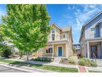Inviting two-story home with a blue door, balcony, covered front porch and an American flag at 1903 W 66Th Ave, Denver, CO 80221