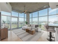 Bright living room with floor to ceiling windows, modern decor, and city view at 1700 Bassett St # 1106, Denver, CO 80202
