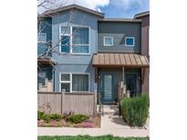 Charming townhouse with colorful exterior, covered entryway, and landscaped front yard with a picket fence at 4150 Longview Ln, Boulder, CO 80301