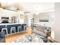 Bright living room featuring modern decor and open floor plan, seamlessly connecting the kitchen and dining areas at 3069 Tejon St # B, Denver, CO 80211