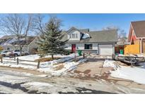 Charming home featuring a well-maintained front yard, attached garage, and inviting red door at 639 Quartz Way, Broomfield, CO 80020