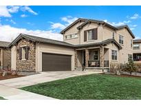 Charming two-story home with a two-car garage and beautifully manicured front lawn at 2190 S Poppy St, Lakewood, CO 80228