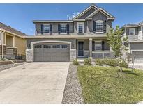 Beautiful two-story home featuring a well-manicured lawn and a two-car garage at 10863 Endeavor Dr, Parker, CO 80134