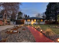 Charming ranch home featuring manicured landscaping and a brick walkway at 6402 E Cornell Ave, Denver, CO 80222