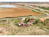 Aerial view of the property and surrounding area, highlighting a farm and nearby highway at 12101 Riverdale Rd, Brighton, CO 80602