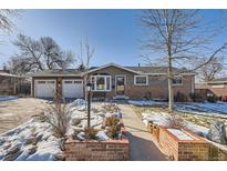 Ranch home with brick facade, attached garage, and landscaped front yard at 6995 S Ash Cir, Centennial, CO 80122