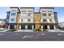 Modern townhome exterior showcasing a contemporary design with a black garage door and multi-tone color scheme at 2920 W Parkside Pl, Denver, CO 80221