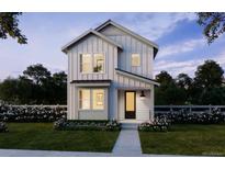 Charming two-story home with a black front door, white picket fence and beautiful landscaping at 8779 Whiteclover St, Littleton, CO 80125