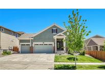 Charming two-story home with a three-car garage and well-manicured lawn, perfect for Gathering living at 16043 Azalea Ave, Parker, CO 80134